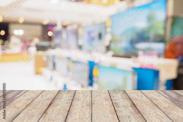 Obraz Wood table over Television shelf in eletronic store blurred background