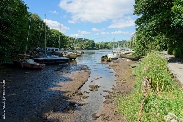 Fototapeta The Helford River in Cornwall England is a tidal river and boats fall dry at low tide
