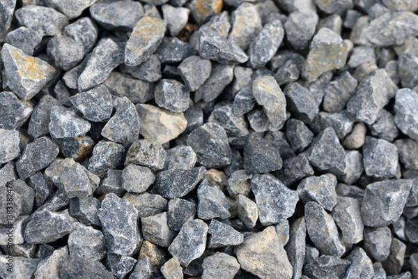 Obraz Natural gravel stones in various shades laid out in a textured surface capturing light and shadow in an outdoor setting