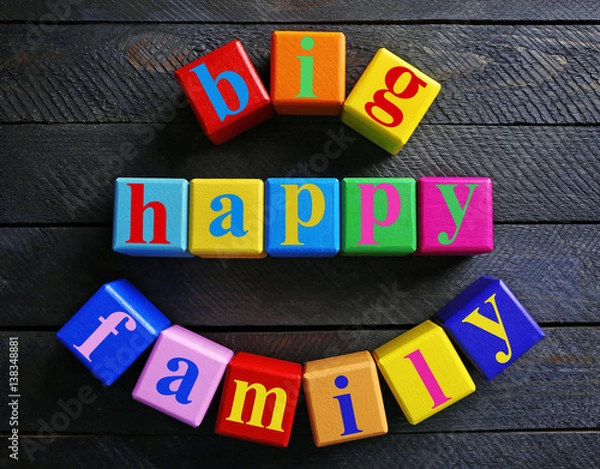Fototapeta Colorful cubes with text BIG HAPPY FAMILY on wooden background