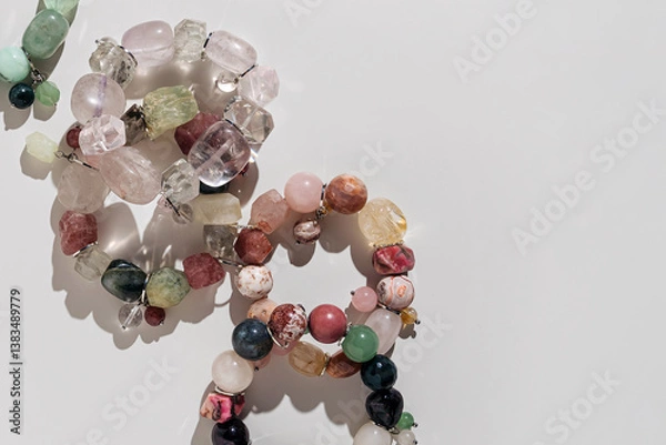 Obraz Assorted gemstone bracelets and raw crystals for crafting. Handmade stone bead bracelets with spiritual meaning. Jewelry with natural stones and beads.