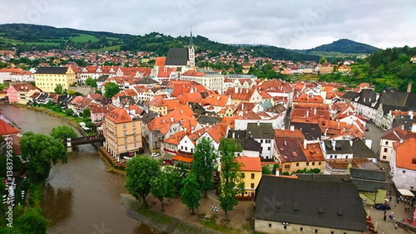 Obraz Cesky Krumlov with colorful buildings and red roofs along the Vltava River on a cloudy day