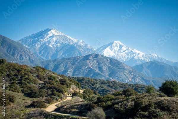 Fototapeta snow capped mountains and trail
