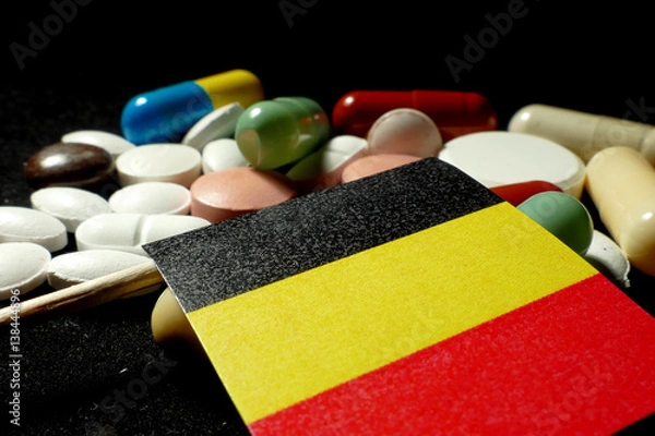 Obraz Belgian flag with lot of medical pills isolated on black background
