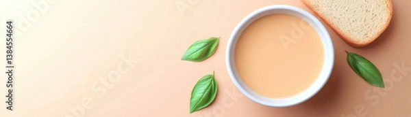 Obraz delicious plant based recipe featuring creamy soup served with slice of bread and fresh leaves, perfect for healthy meal