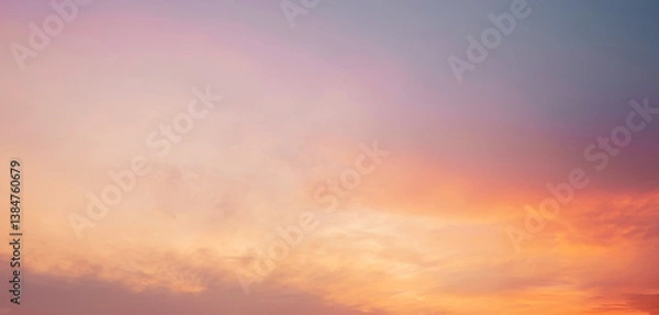 Fototapeta Serene and peaceful sunset sky with soft, hazy clouds and warm orange tones. Background photos for banners, posters and wallpapers.