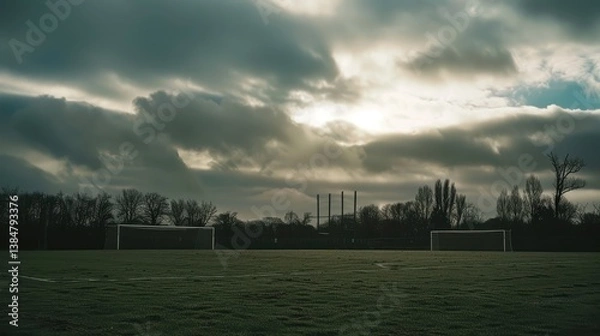 Obraz Serene Soccer Field Under Dramatic Sky with Clouds and Trees
