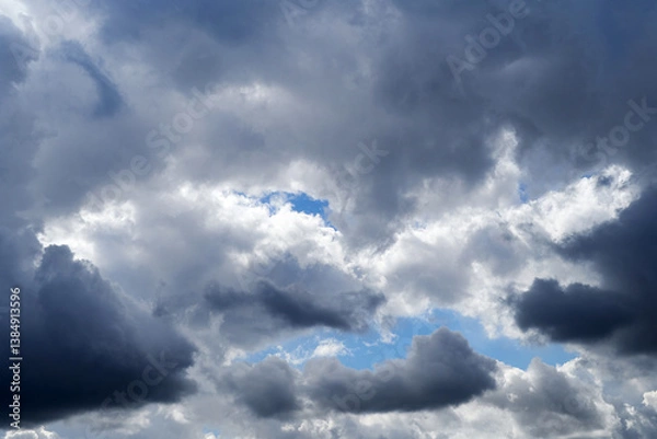 Fototapeta Cloudy pre-storm sky. Dark and white clouds on a background of blue sky