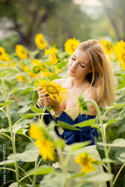 Obraz Cute european young model girl posing and having fun in a field full of blooming sun flowers. Showing freedom, innocence and youth