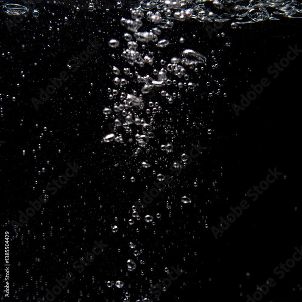 Fototapeta Bubbles rising in water create a mesmerizing underwater effect during a quiet moment