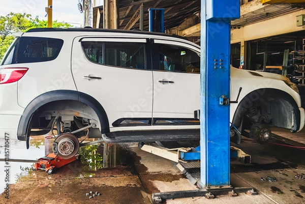 Obraz Change new car tires. Process of checking the condition of new tires. Repair tire puncture. Checking and filling air pressure. Car repairs. Car breakdowns. Concept of car tire maintenance and repair