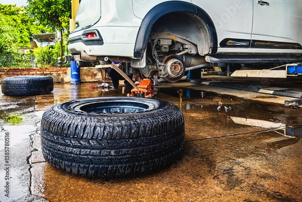 Obraz Change new car tires. Process of checking the condition of new tires. Repair tire puncture. Checking and filling air pressure. Car repairs. Car breakdowns. Concept of car tire maintenance and repair