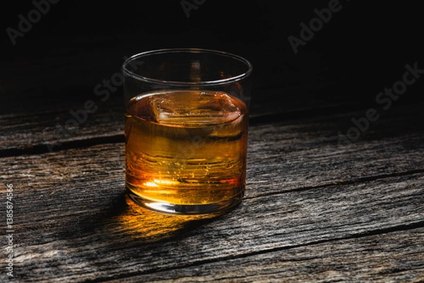 Obraz Bourbon in a glass on old wood table
