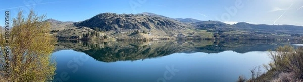 Fototapeta Wapato Lake in a sweeping panoramic view as seen from the Manson Scenic Loop drive with reflections on a beautiful early spring morning_20250405.4041.