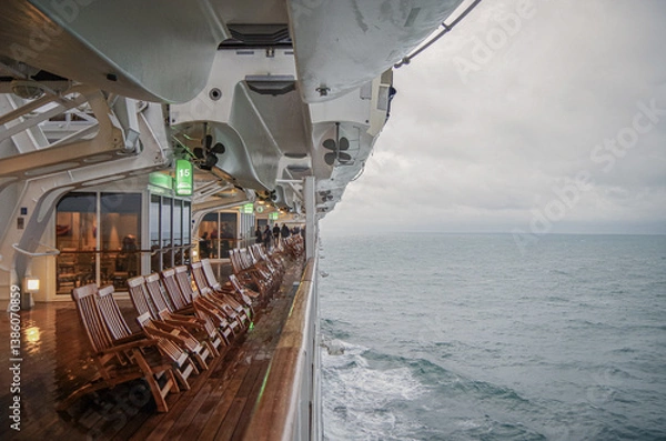 Fototapeta Views onto wet outdoor teak balcony terrace veranda promenade boat deck of ocean liner cruiseship cruise ship with chairs and loungers at sea during 