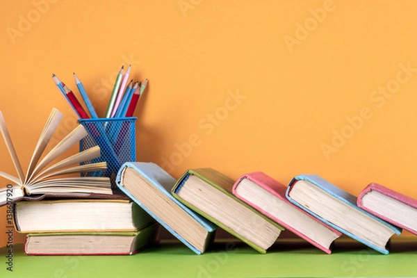 Fototapeta Open book, hardback bookson bright colorful background.