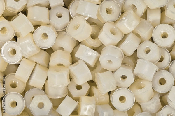 Fototapeta White plastic nylon nuts many scattered hardware work tools accessories.