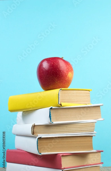 Obraz Books stacking. Books on wooden table and blue background. Back to school. Copy space for ad text.