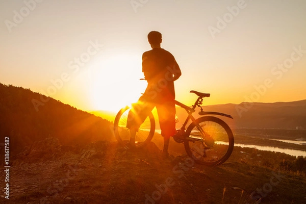 Obraz Biker resting while watching sunset