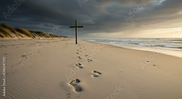 Fototapeta Footprints in sand leading to a cross — journey to resurrection.