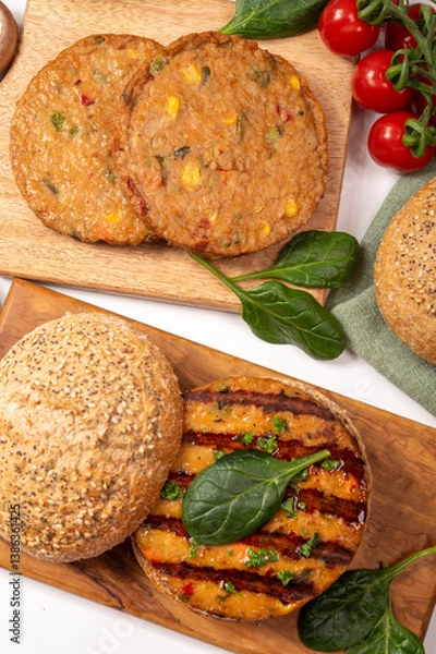 Fototapeta Make burger buns with vegan or vegetarian patties or burgers made from soybeans, grains, vegetables, grilled healthy food