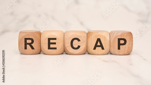 Obraz Wooden blocks spelling "RECAP" on a marble surface, symbolizing summaries or conclusions.