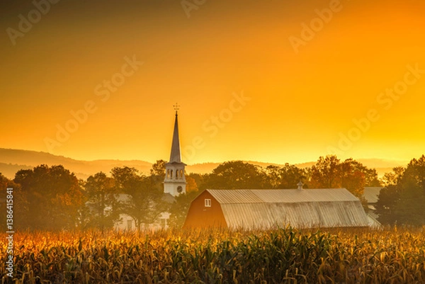 Obraz Morning light falls over a red barn and church in Peacham, Vermont