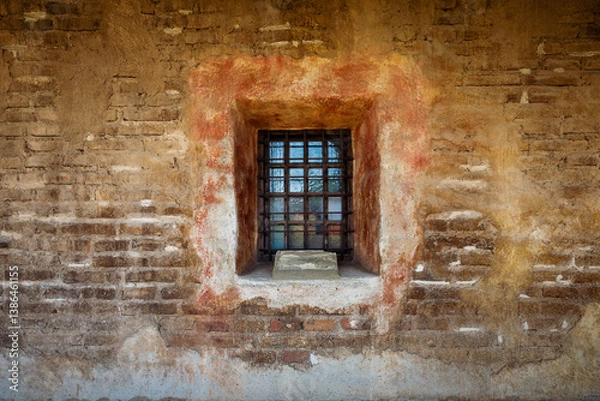 Fototapeta rustic barred window at mission in San Juan Capistrano