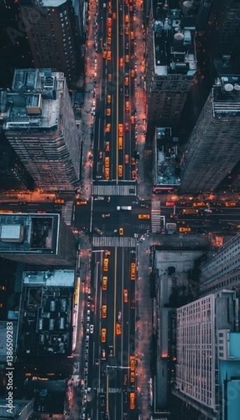 Obraz Aerial view of a bustling urban intersection at dusk, showcasing vibrant city lights and traffic flow amidst towering skyscrapers, highlighting the dynamic nature of city life