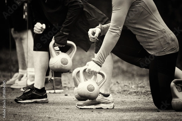 Fototapeta People doing keep fit exercise in park