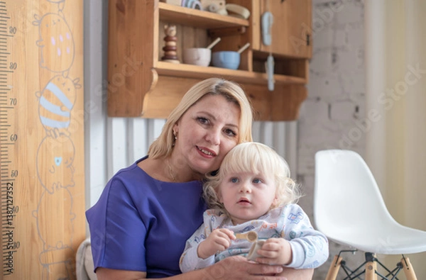 Fototapeta Grandmother with grandson boy at home. Relatives bonding and generational communication. Old lady and child having fun together.