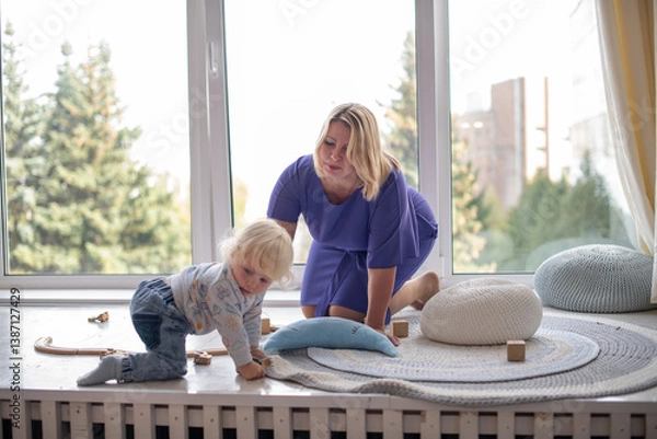 Fototapeta Grandmother with grandson boy at home. Relatives bonding and generational communication. Old lady and child having fun together.