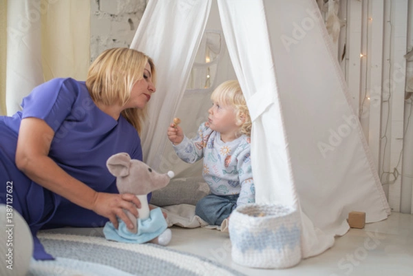 Fototapeta Grandmother with grandson boy at home. Relatives bonding and generational communication. Old lady and child having fun together.