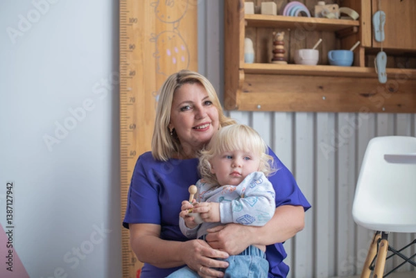 Fototapeta Grandmother with grandson boy at home. Relatives bonding and generational communication. Old lady and child having fun together.