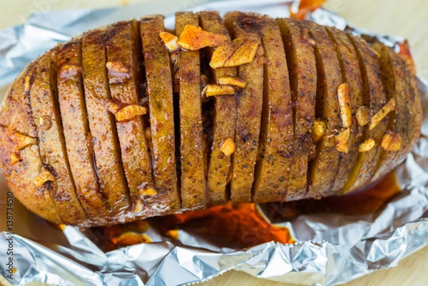 Obraz Prepared for oven hasselback potatoes with smoked paprika and bacon.