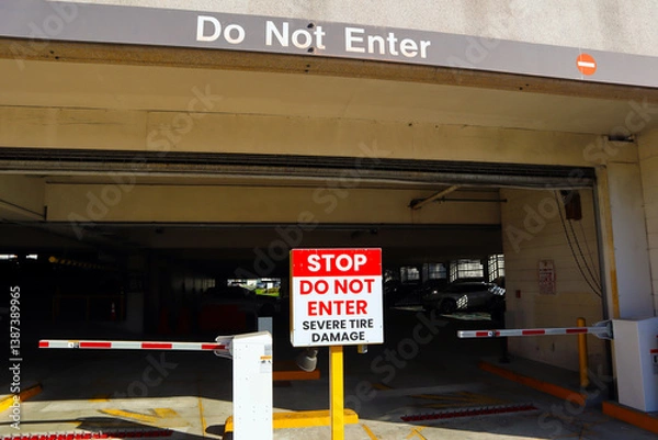 Fototapeta Public Garage Exit with "STOP Do Not Enter, Severe Tire Damage" Sign