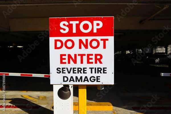 Fototapeta Public Garage Exit with "STOP Do Not Enter, Severe Tire Damage" Sign