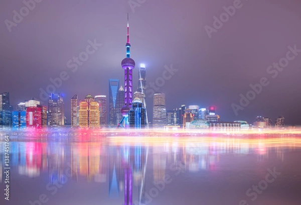 Obraz Shanghai colorful skyline with motion speed light of passing ferry in the foreground at night - Shanghai, China