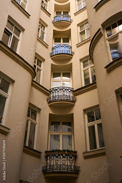 Obraz Walls rise like whispers, curving in quiet harmony. Shadows slip across their faces as time holds its breath in this still, sunlit courtyard of memory and grace.
