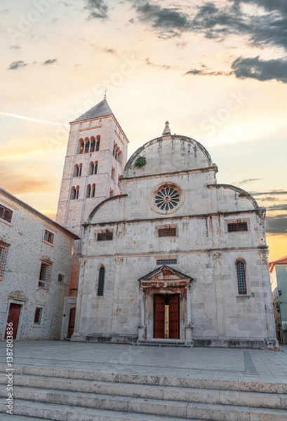 Obraz The beautiful Renaissance-style Church of St. Chrysogonus with its Romanesque bell tower stands proudly in the historic old town of Zadar, Croatia, glowing under the soft light of sunset.