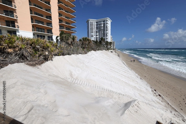 Obraz In anticipation of adding a sea wall on oceanfront property, a sand replenishment project was done to mitigate beach erosion.