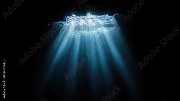 Fototapeta Sunlight piercing a dark underwater cave
