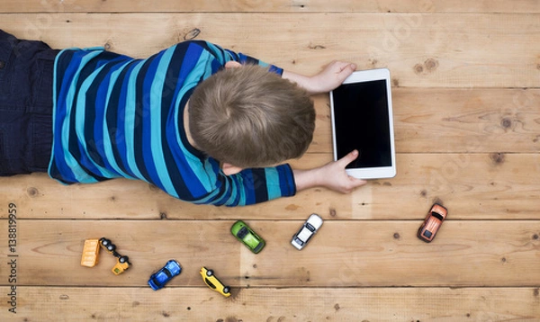 Fototapeta Young kid using tablet PC header image