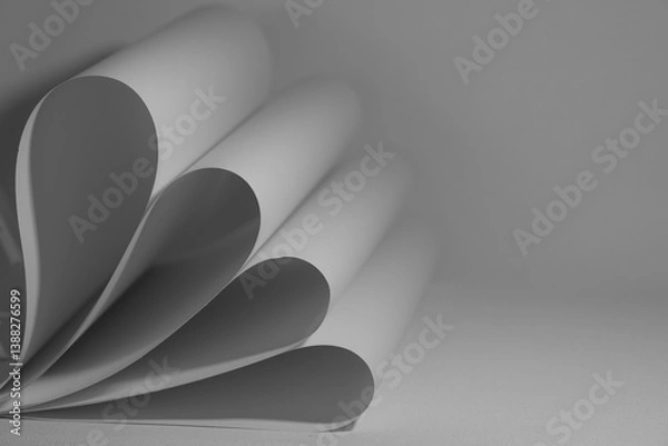 Fototapeta Pages of a book fanned out on a soft surface in a minimalist setting during daylight hours