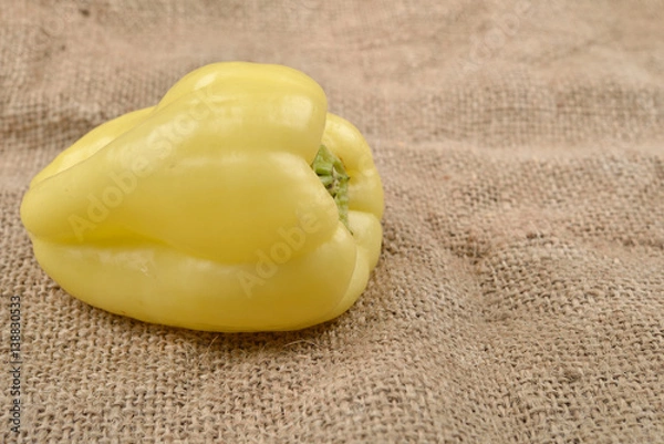 Obraz Sweet yellow pepper lying on jute canvas background. Concept of healthy food, bio from countryside