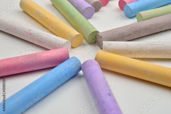Obraz Close up of a lot of colored chalk pieces on on a white background. Back to school,education, arts, creative