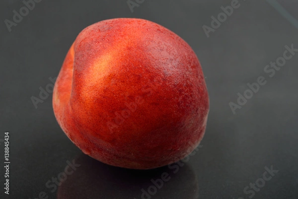 Obraz Close up image of red and fresh peach on black background. Selective focus