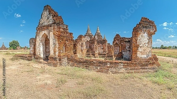 Fototapeta Ancient weathered brick structures on a bright sunny cloud filled day
