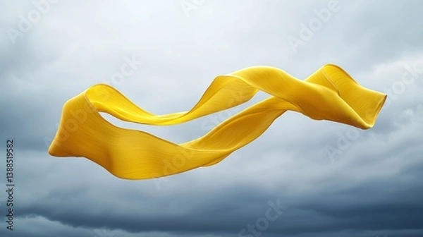 Fototapeta Twisting yellow ribbon caught mid-air, soft motion effect, with a calm gray clouded sky, symbolic of sorrow and remembrance, clean composition