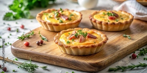 Fototapeta Delicious Mini Quiches with Creamy Filling and Herb Garnish on Rustic Wooden Board